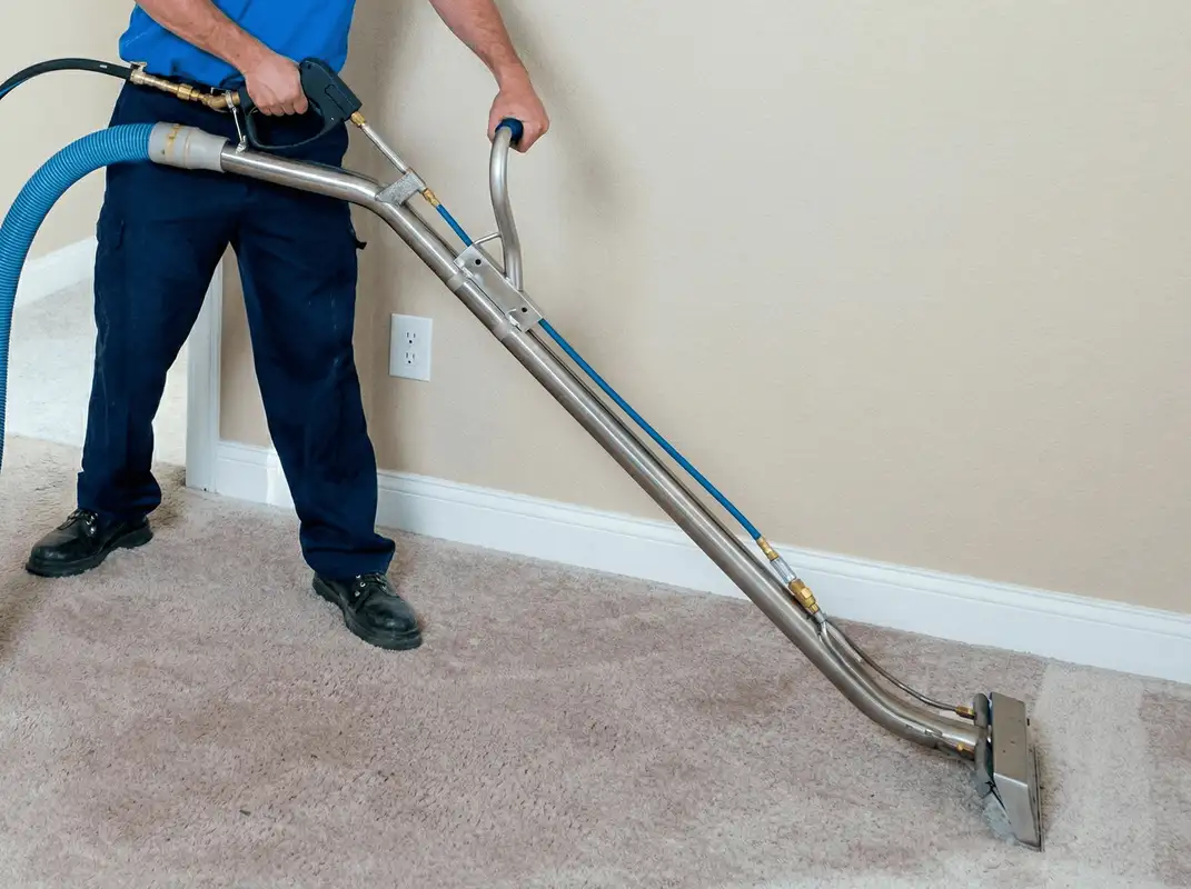 Professional operating a liquid removal machine on a carpeted floor in Erie, PA